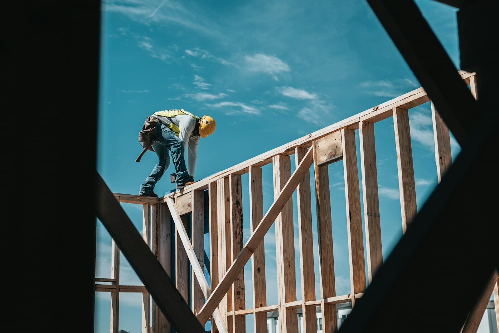 Contractor framing a new wood structure on a construction site