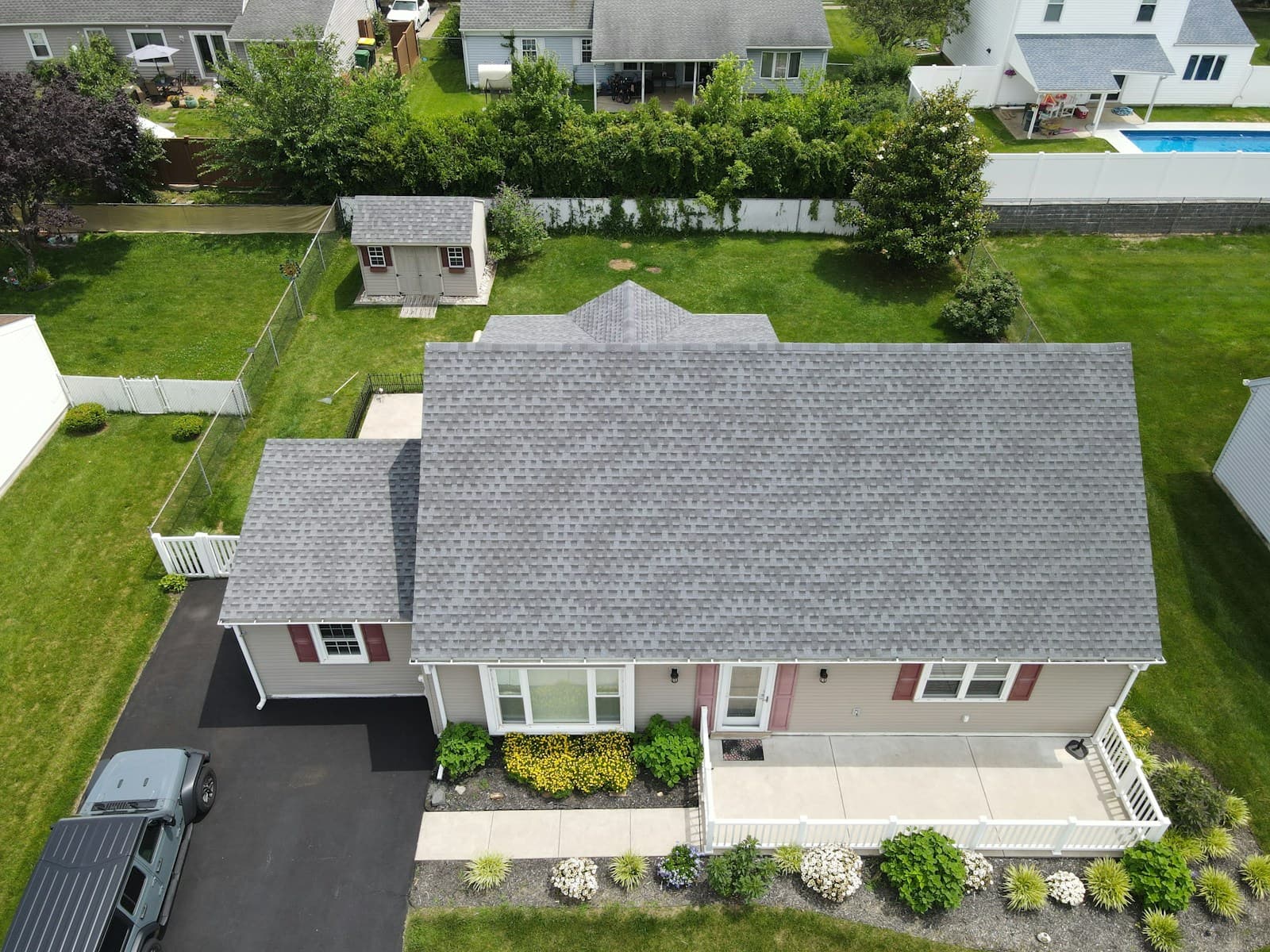 Aerial view of a newly installed asphalt shingle roof on a residential home